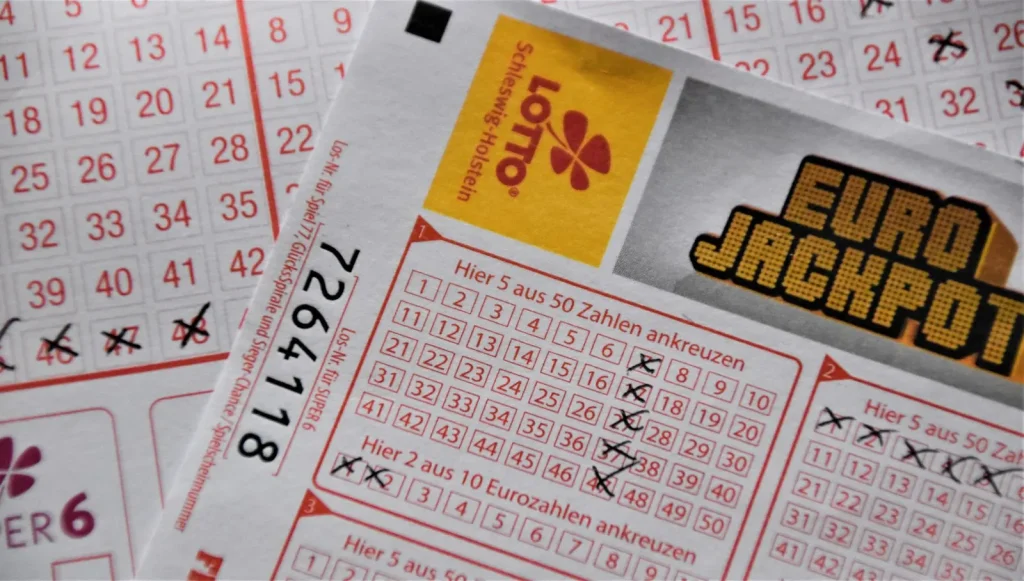 Close-up of a printed lottery ticket with numbered grids marked by hand