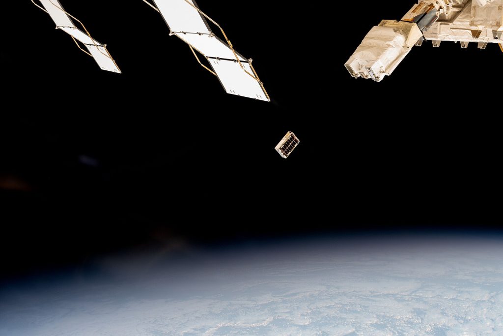 A CubeSat is ejected into Earth orbit from a small satellite orbital deployer (iss072e351959)