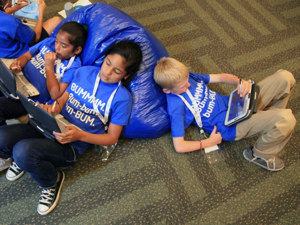 Children using tablet computers together indoors