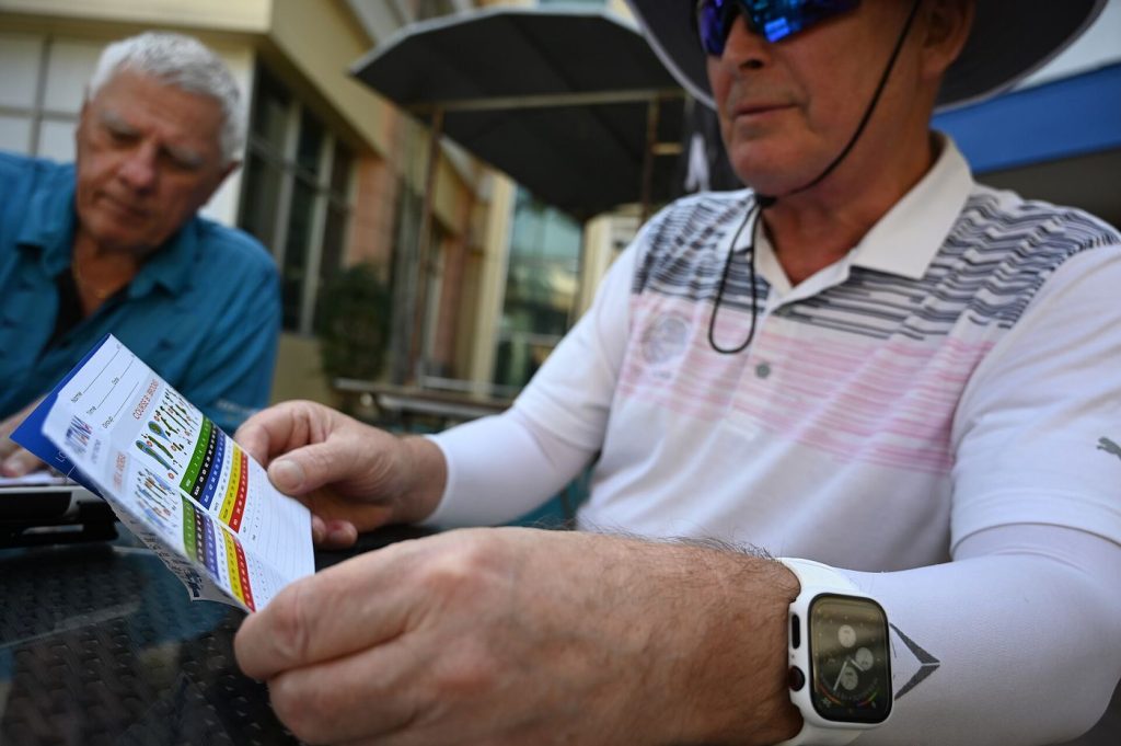 Man wearing a smartwatch while reading health information